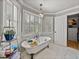Bright bathroom featuring a clawfoot tub, chandelier, and built-in shelving at 4611 Ackerly Way, Brandon, FL 33511