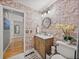 This bathroom features a vanity with marble countertops and hardwood floors at 4611 Ackerly Way, Brandon, FL 33511