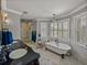 This bathroom features a stand alone tub, a stand up shower, and natural lighting at 4611 Ackerly Way, Brandon, FL 33511