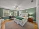 Bedroom with bright green walls, hardwood floors, and lots of natural light at 4611 Ackerly Way, Brandon, FL 33511