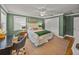 This bedroom features hardwood floors, a ceiling fan, and a large double door closet at 4611 Ackerly Way, Brandon, FL 33511