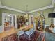 Dining room showcases a chandelier, area rug, and wood furniture that provides a comforting space at 4611 Ackerly Way, Brandon, FL 33511