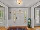 Charming entryway with a white front door, sidelights, hardwood floors, and decorative accents at 4611 Ackerly Way, Brandon, FL 33511