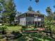 Stunning two-story home features a balcony, a well-maintained lawn, and lush landscaping with mature trees at 4611 Ackerly Way, Brandon, FL 33511