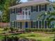 A lovely two-story home with a balcony, well-manicured lawn, a landscaped garden, and dark window shutters at 4611 Ackerly Way, Brandon, FL 33511