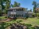 Attractive two-story home with a balcony, landscaped front yard, brick walkway, and dark shutters on the windows at 4611 Ackerly Way, Brandon, FL 33511