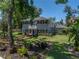 Lovely two-story home with balcony, surrounded by an amazing landscape with mature trees and a brick walkway at 4611 Ackerly Way, Brandon, FL 33511