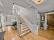Elegant foyer featuring hardwood floors, a staircase, and stylish decor elements at 4611 Ackerly Way, Brandon, FL 33511