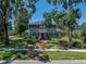Traditional home boasting a brick pathway, manicured lawn, and a charming balcony, surrounded by beautiful trees at 4611 Ackerly Way, Brandon, FL 33511