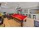 Entertainment room offers a billiard table, comfortable couches, a bar area and seamless indoor-outdoor living at 4611 Ackerly Way, Brandon, FL 33511