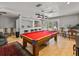 Spacious game room features a billiard table, bar area, and seating, perfect for entertainment at 4611 Ackerly Way, Brandon, FL 33511