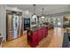 Open kitchen with a red island, stainless steel appliances, and gray cabinets at 4611 Ackerly Way, Brandon, FL 33511