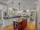 Charming kitchen features a central island, white cabinets, and modern appliances for cooking at 4611 Ackerly Way, Brandon, FL 33511