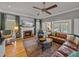 Spacious living room features a fireplace, leather sofa, and doors to the outdoor pool at 4611 Ackerly Way, Brandon, FL 33511