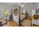 Main bedroom showcasing a four-poster bed, wood floors, and calming decor at 4611 Ackerly Way, Brandon, FL 33511