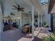 Spacious covered patio with ceiling fans, seating and dining areas at 4611 Ackerly Way, Brandon, FL 33511