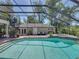 Sparkling pool inside screen enclosure with an adjacent spa and outdoor seating area at 4611 Ackerly Way, Brandon, FL 33511