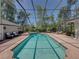 Enclosed pool area featuring a large in-ground pool and lounge seating at 4611 Ackerly Way, Brandon, FL 33511