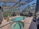 Covered pool and spa area with brick pavers, spiral staircase and access to second story deck at 4611 Ackerly Way, Brandon, FL 33511