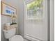 Toilet room with a window, art, and woven basket at 4611 Ackerly Way, Brandon, FL 33511