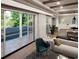 Sun-filled living room with sliding doors, with views of the pool and outdoor spaces at 4612 W Tennyson Ave, Tampa, FL 33629