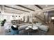 Bright, open-concept living room with a gray rug, modern furniture, exposed wood beams, and a staircase at 4612 W Tennyson Ave, Tampa, FL 33629