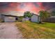 The home features a spacious backyard and shed, all complemented by a stunning sunset at 4684 72 N Ave, Pinellas Park, FL 33781