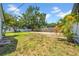 A well-maintained backyard with healthy grass, brick patio, and mature landscaping, perfect for relaxation at 4684 72 N Ave, Pinellas Park, FL 33781