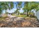 This backyard view shows the home with a shed and mature trees under a clear blue sky at 4684 72 N Ave, Pinellas Park, FL 33781