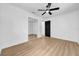 Bedroom featuring light wood floors, fan, and sliding closet doors at 4684 72 N Ave, Pinellas Park, FL 33781