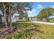 View of the house from the side yard, showing off the new gravel driveway and freshly painted exterior at 4684 72 N Ave, Pinellas Park, FL 33781