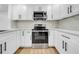 Close-up view of a modern kitchen featuring sleek stainless steel appliances and white cabinetry at 4684 72 N Ave, Pinellas Park, FL 33781