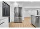 Modern kitchen featuring stainless steel refrigerator, white cabinets, and wood-look flooring at 4684 72 N Ave, Pinellas Park, FL 33781