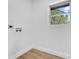 A clean laundry room has modern painted walls and new wood floors at 4684 72 N Ave, Pinellas Park, FL 33781
