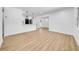 Bright, airy living room featuring wood-look flooring and white walls, flowing into the open kitchen area at 4684 72 N Ave, Pinellas Park, FL 33781