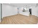 Bright, open-concept living room featuring wood-look floors and an open flow into the modern kitchen at 4684 72 N Ave, Pinellas Park, FL 33781