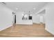 An open-concept living area with wood-look flooring, leading into the well-lit kitchen at 4684 72 N Ave, Pinellas Park, FL 33781