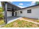 A covered patio features an outdoor area and updated landscaping at 4684 72 N Ave, Pinellas Park, FL 33781
