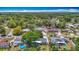 An aerial view of a charming neighborhood with tree-lined streets and well-maintained homes under a beautiful sunny sky at 4915 Chariton Ave, Tampa, FL 33603