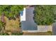 Back aerial of home featuring nice roof, landscaping, and drive at 4915 Chariton Ave, Tampa, FL 33603