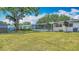 Spacious backyard with the enclosed patio attached to the home at 4915 Chariton Ave, Tampa, FL 33603