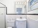 Updated bathroom with a shower, toilet, sink, vanity, and mirrored cabinet at 4915 Chariton Ave, Tampa, FL 33603