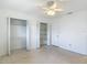 White bedroom featuring a ceiling fan, terrazzo floors, and a closet at 4915 Chariton Ave, Tampa, FL 33603