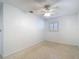 This carpeted bedroom includes a ceiling fan and bright white walls providing a blank canvas at 4915 Chariton Ave, Tampa, FL 33603