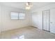 Bright bedroom with terrazzo floors, closet, and window with blinds at 4915 Chariton Ave, Tampa, FL 33603