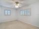 Bright bedroom featuring neutral carpet, a ceiling fan, and plantation shutters for ample natural light at 4915 Chariton Ave, Tampa, FL 33603