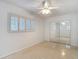 Bright bedroom with ceiling fan, plantation shutters, and mirrored closet doors at 4915 Chariton Ave, Tampa, FL 33603
