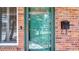 Close-up of the home's ornate glass-paneled front door and a mailbox on the brick facade at 4915 Chariton Ave, Tampa, FL 33603