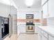 Bright kitchen with white cabinets, stainless steel refrigerator and oven range at 4915 Chariton Ave, Tampa, FL 33603