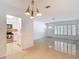 Bright living room providing a view into the kitchen. Features retro floors and recessed lighting at 4915 Chariton Ave, Tampa, FL 33603